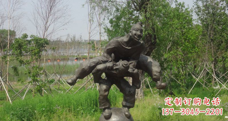 保定园林站在球上面跳山羊的人物景观铜雕